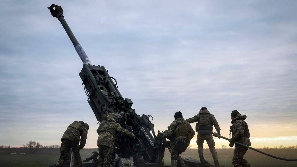 Ukrainian soldiers prepare a U.S.-supplied M777 howitzer to fire at Russian positions in the Kherson region if Ukraine on Jan. 9, 2023. (Libkos/AP)
