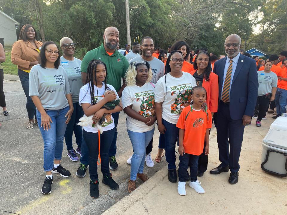 Lynesia White (middle row, third from right) stands with her three daughters and FAMU VP of University Advancement Shawnta Friday-Stroud (second from right). FAMU President Larry Robinson (last on right), Big Bend Habitat for Humanity Executive Director Antoine Wright (back row, third from left) and Whirlpool Corporation team members.
