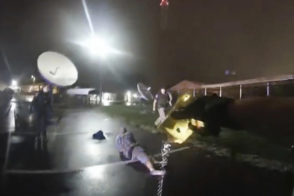 FILE - In this image from Altoona Police Department body-camera video, police approach Demetrio Jackson in a parking lot near Altoona and Eau Claire, Wis., on Oct. 8, 2021. Jackson’s death shows how police violate safety guidelines by using stun guns on people who are medically vulnerable, heightening their risk of sudden death. Jackson had taken methamphetamine, and one officer later wondered whether he had a disputed condition, called “excited delirium,” that police say causes potentially life-threatening symptoms. In addition to getting shocked, he was restrained facedown and injected with a knockout drug. (Altoona Police Department via AP, File)