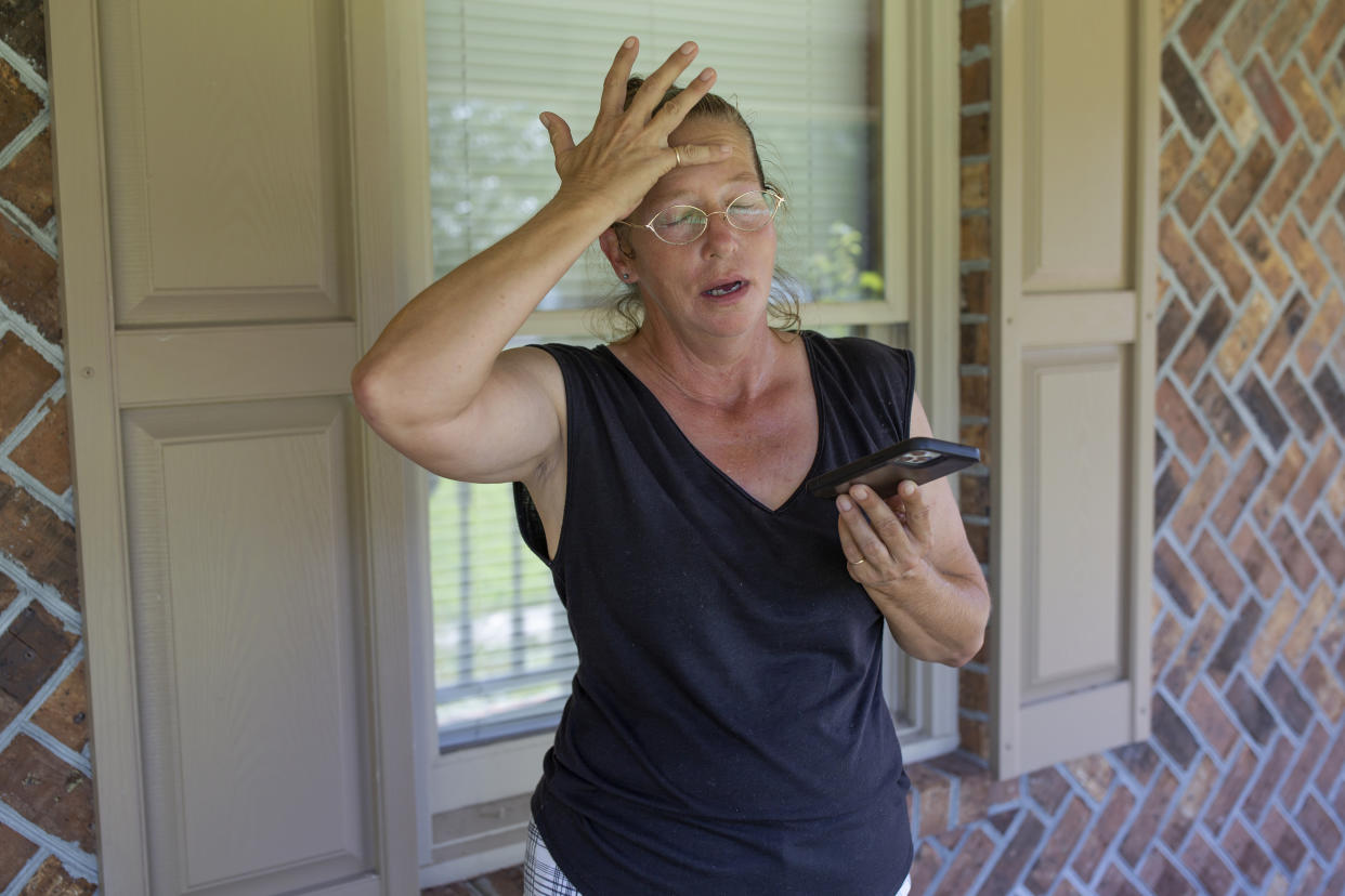 Terri Straka stands on the porch of her new home while she finalizes details with a real estate agent in Myrtle Beach, South Carolina on September 19, 2022. (Credit: Madeline Gray for The Washington Post via Getty Images)