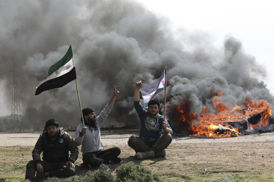 Syrians block the main highway in Neyrab, Sunday, March 15, 2020 as they protest agreement on joint Turkish and Russian patrols in northwest Syria. Patrols on the M4 highway, which runs east-west through Idlib province, are part of a cease-fire agreed between Turkey and Russia after an escalation in fighting that saw the Turkish military in direct conflict with Syrian government troops.( (AP Photo/Ghaith Alsayed)