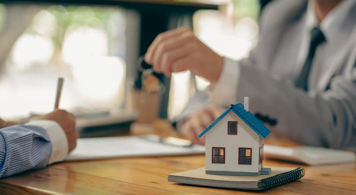 A real estate investor signing the paperwork for their latest investment property.