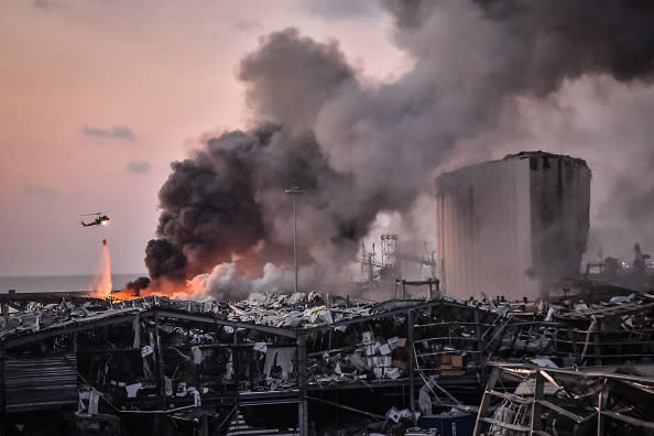 A military helicopter tries to put out a fire at the port after the explosion on in Beirut, Lebanon. 