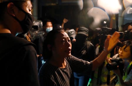 A pro-government supporter argues with anti-government protesters during a demonstration in Tin Shui Wai in Hong Kong