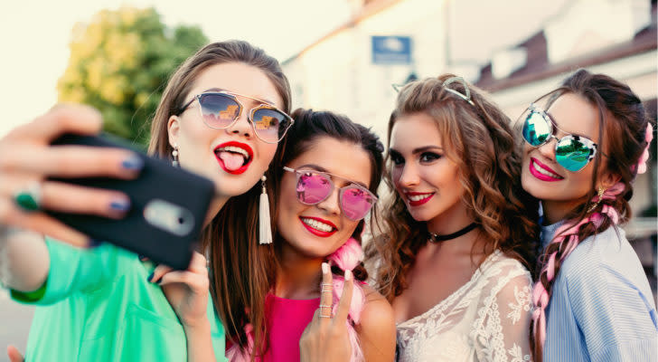 Image of teen girls taking a selfie on a shopping trip.