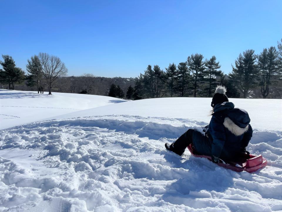 Eleanor Dowling, of Quincy, took her her 5-year-old daughter Colby sledding at Quincy's Furnace Brook Golf Course on Sunday, Jan. 30, 2022.