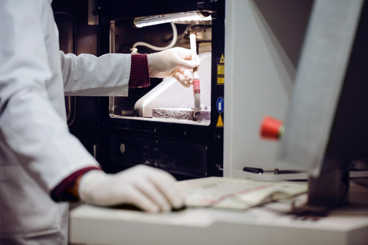 worker brushing powder off 3d powder printer