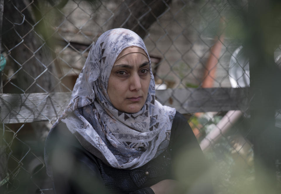 Somaya, the wife of Palestinian Osama Mansour, who was shot to death by Israeli soldiers at a temporary checkpoint in the occupied West Bank earlier this month, speaks to journalists at her family house, in the West Bank village of Biddu, west of Ramallah, Tuesday, April 20, 2021. Somaya, who was in the car with her husband and was wounded by the gunfire, says they followed the soldiers' instructions and posed no threat. The shooting death has revived criticism of the Israeli military's use of deadly force. (AP Photo/Nasser Nasser)