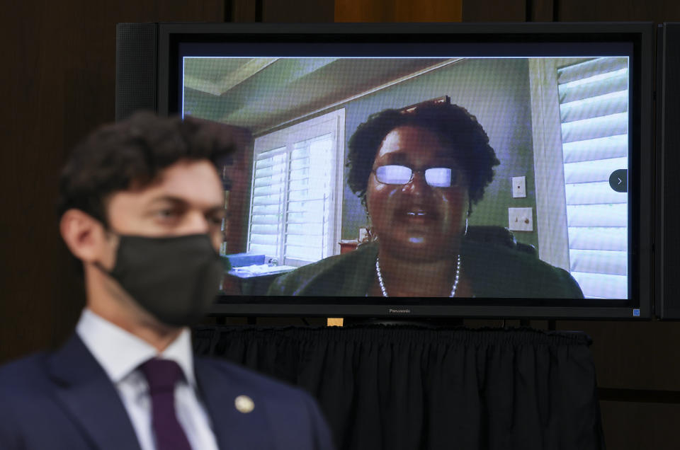 Stacey Abrams testifies remotely via video conference as Sen. Jon Ossoff, D-Ga., listens during a Senate Judiciary Committee hearing on voting rights on Capitol Hill in Washington, Tuesday, April 20, 2021. (Evelyn Hockstein/Pool via AP)