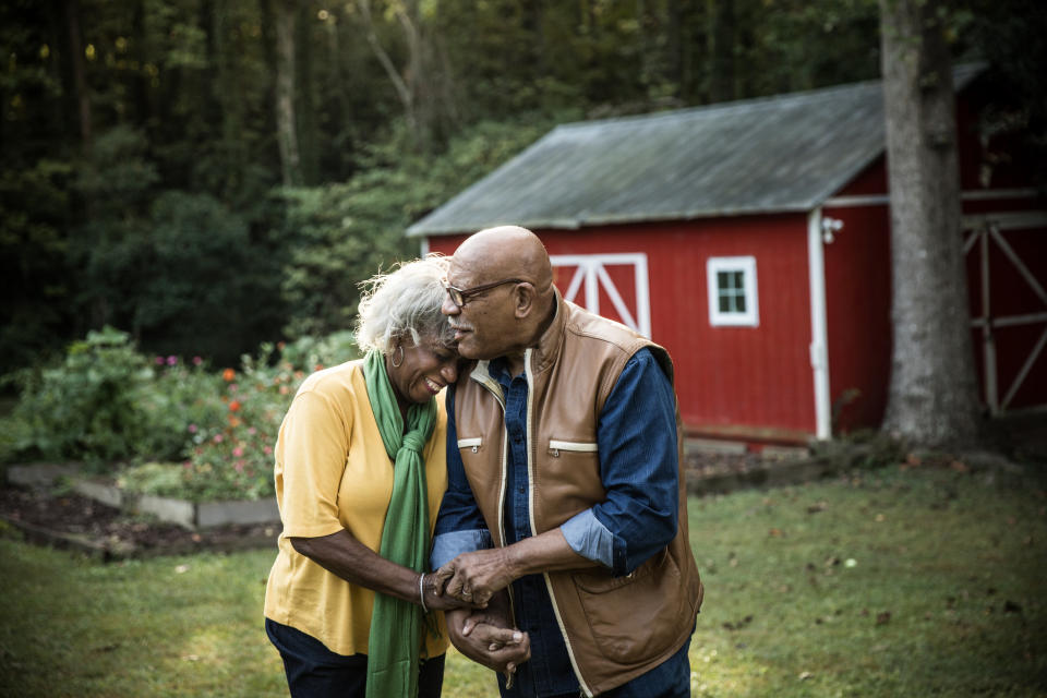 A couple holds hands outside