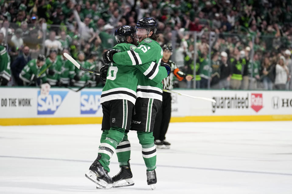 Dallas Stars' Joe Pavelski, left, and Thomas Harley, right, celebrate after Pavelski scored in the first period of Game 1 of an NHL hockey Stanley Cup second-round playoff series against the Seattle Kraken, Tuesday, May 2, 2023, in Dallas. The score was Pavelski's second of the game. (AP Photo/Tony Gutierrez)