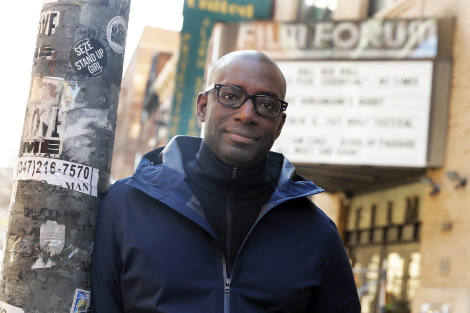 In this March 26, 2019, photo Stacy Spikes, co-founder of MoviePass, poses for a photo outside the Film Forum theater, in New York. After selling the company, he watched from the sidelines as new owners quickly expanded, only to find the cost of all those movie tickets too high to sustain. Spikes spoke with The Associated Press recently about the state of movie theaters. (AP Photo/Richard Drew)