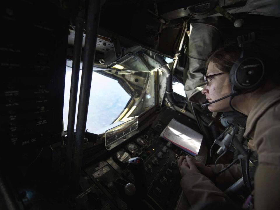 U.S. Air Force Senior Airman Rebekah McCormack looks out the boom pod window of a KC-135 Stratotanker over Iraq, Dec. 22, 2015.