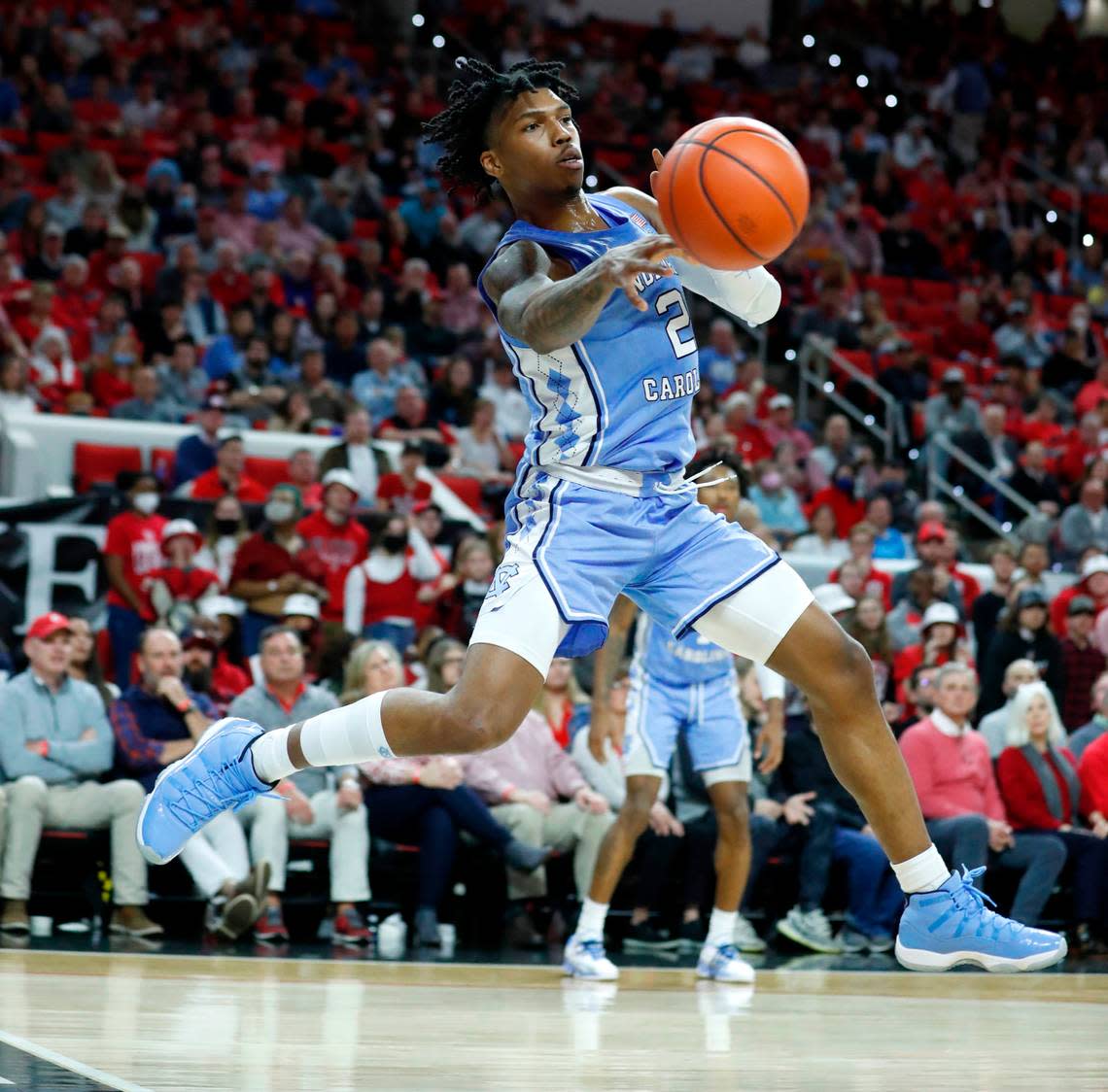 North Carolina’s Caleb Love (2) passes the ball during the first half of N.C. State’s game against UNC at PNC Arena in Raleigh, N.C., Saturday, Feb. 26, 2022.