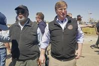 Mississippi Gov. Tate Reeves and U.S. Rep. Bennie Thompson, D-Miss. look over remnants of homes destroyed by tornado, Sunday, March 23, 2023, in Rolling Fork, Miss. (AP Photo/Rogelio V. Solis)