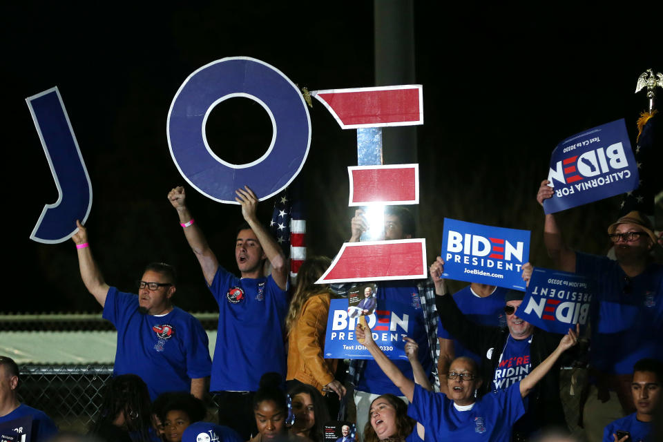 LOS ANGELES, CALIFORNIA - MARCH 03: Joe Biden supporters hold  signs ahead of Biden's Super Tuesday night event on March 03, 2020 in Los Angeles, California. 1,357 Democratic delegates are at stake as voters cast their ballots in 14 states and American Samoa on what is known as Super Tuesday. (Photo by Mario Tama/Getty Images)