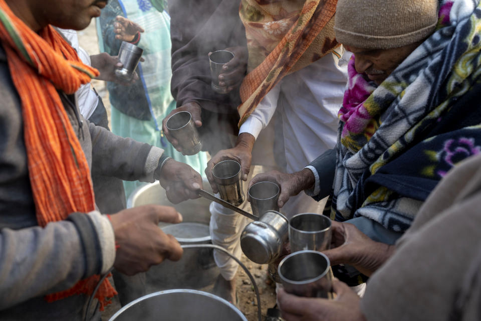 Indian pilgrims wait for their turn to receive a cup of tea before they embark on a visit to the sacred Pashupatinath temple in Kathmandu, Nepal, Jan. 9, 2024. The centuries-old temple is one of the most important pilgrimage sites in Asia for Hindus. Nepal and India are the world’s two Hindu-majority nations and share a strong religious affinity. Every year, millions of Nepalese and Indians visit Hindu shrines in both countries to pray for success and the well-being of their loved ones. (AP Photo/Niranjan Shrestha)
