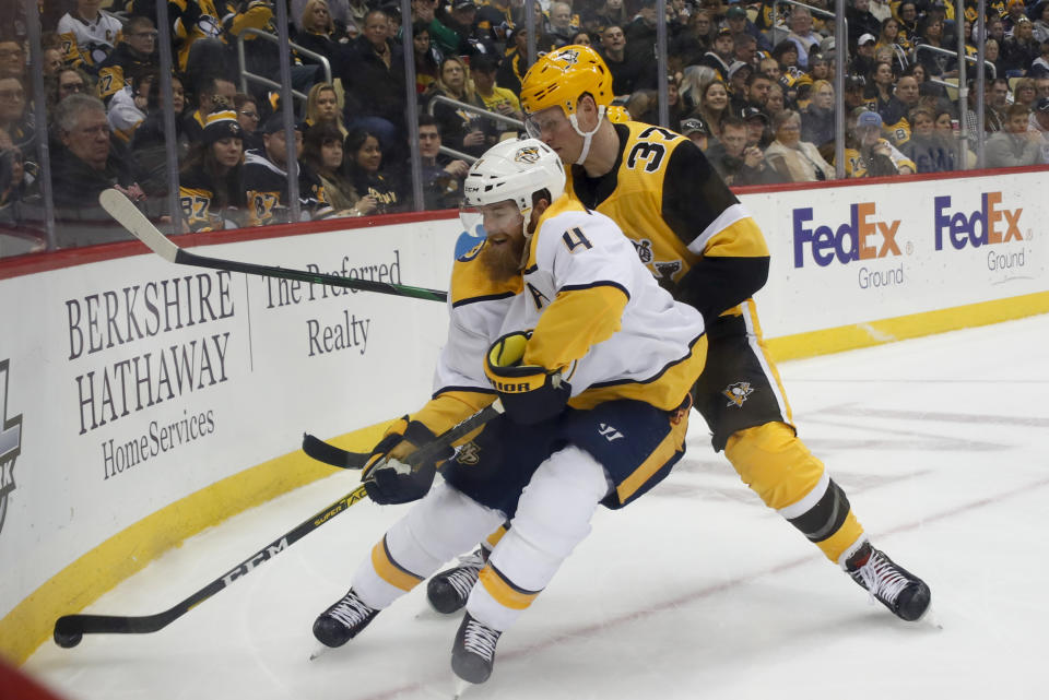 Nashville Predators' Ryan Ellis (4) goes into the corner for the puck as Pittsburgh Penguins' Sam Lafferty (37) pursues during the second period of an NHL hockey game Saturday, Dec. 28, 2019, in Pittsburgh. (AP Photo/Keith Srakocic)