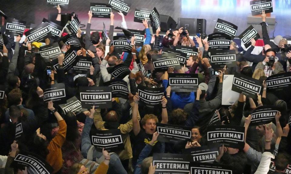 fetterman supporters, many of them young people, celebrate with signs on election night