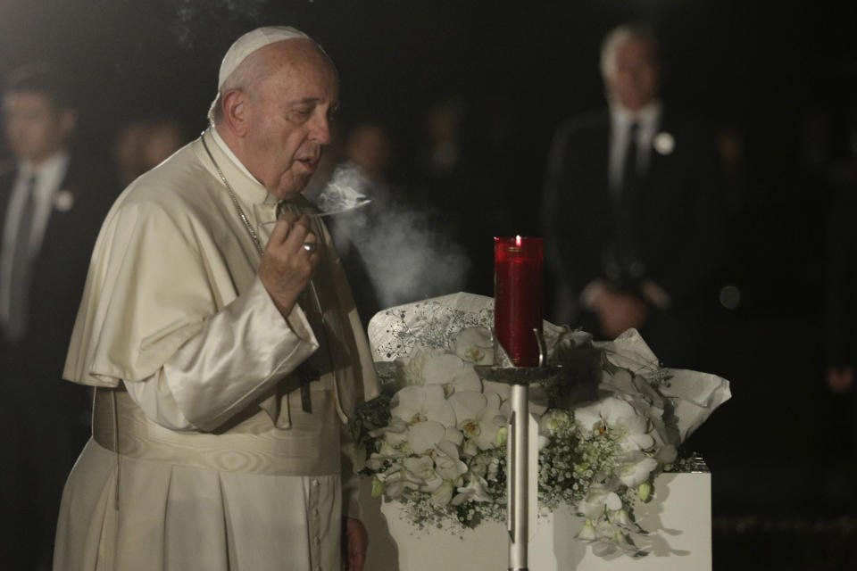 Pope Francis blows out after lighting a candle as he visits Hiroshima Peace Memorial Park in Hiroshima, western Japan, Sunday, Nov. 24, 2019. (AP Photo/Gregorio Borgia)