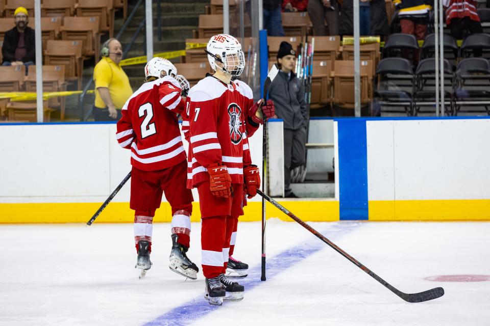 Spaulding senior Jackson Emrich of Spaulding watches members of the Oyster River boys hockey team celebrate following its 3-0 win in the Division II state championship game at Southern New Hampshire University Arena in Manchester.