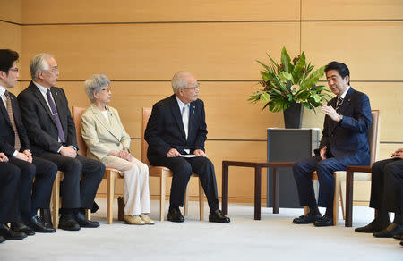 Japan's Prime Minister Shinzo Abe (R) meets family members of victims abducted to North Korea at the Prime Minister's official residence in Tokyo, Japan, June 14, 2018. Kazuhiro Nogi/Pool via Reuters