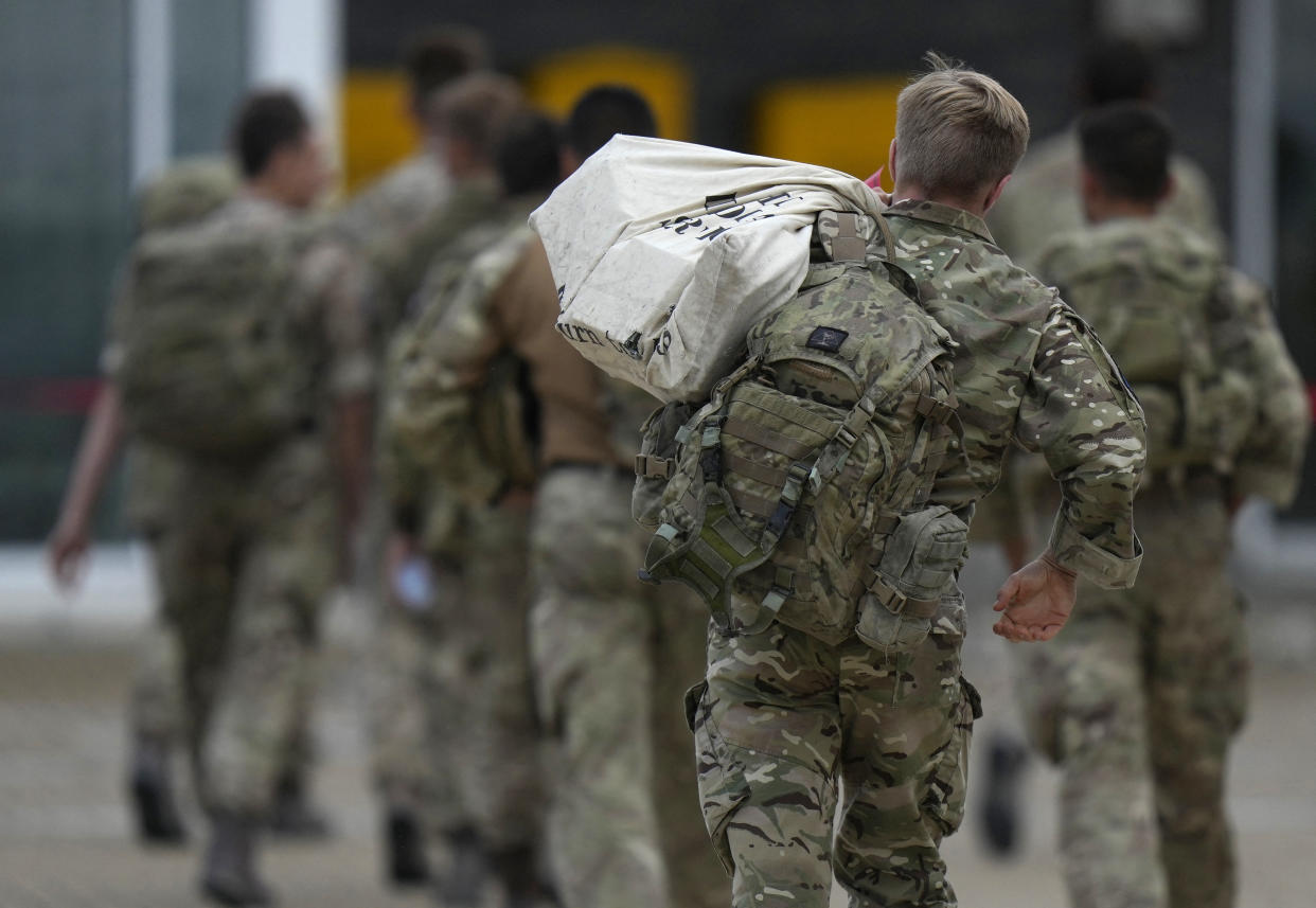 Members of the British armed forces 16 Air Assault Brigade walk to the air terminal after disembarking a Royal Airforce Voyager aircraft at Brize Norton, Oxfordshire on August 28, 2021, as the troops return from assisting with the evacuation of people from Kabul airport in Afghanistan.