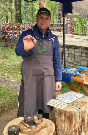 Sergei Brik, who strikes souvenir coins for tourists, poses for a picture in Yekaterinburg, Russia June 16, 2018. REUTERS/Mark Trevelyan