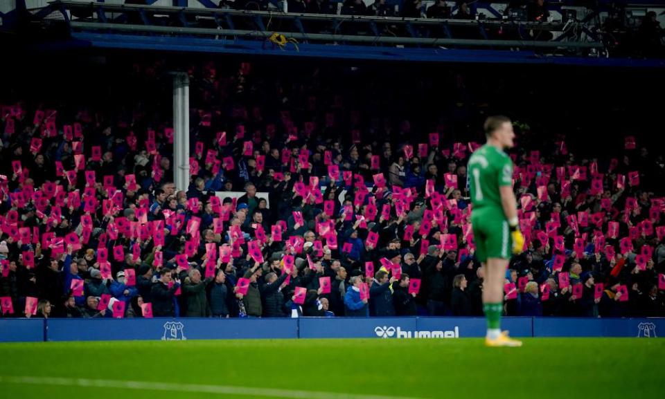 Everton fans hold banners protesting against the Premier League