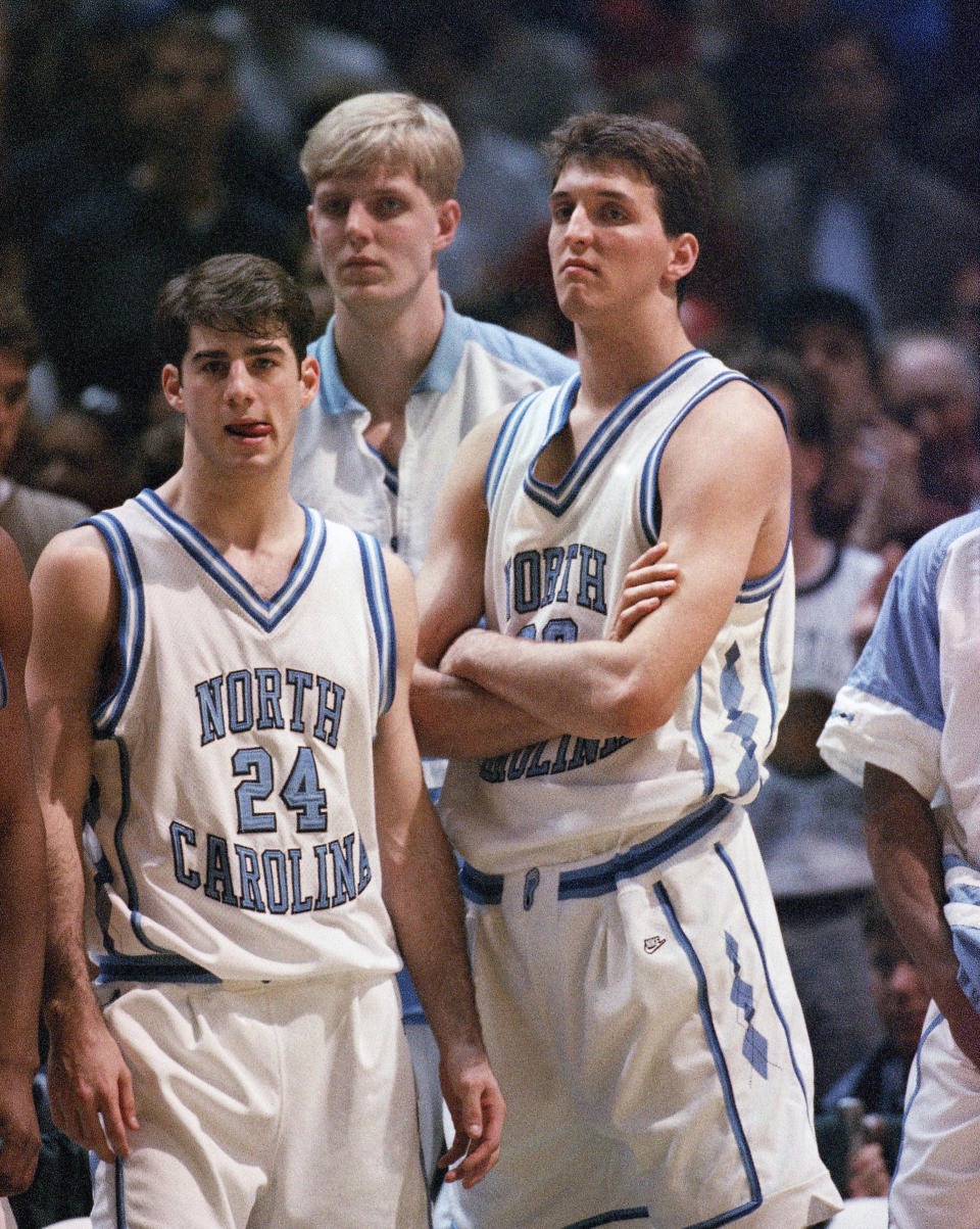 North Carolina guard Dante Calabria, (24), Serge Zwikker, center, and forward Kevin Salvadori, right, stare in disbelief after their team is defeated by Boston College, 75-72, during the East Regional second-round game, March 20, 1994, Landover, Maryland. AP Photo/Doug Mills