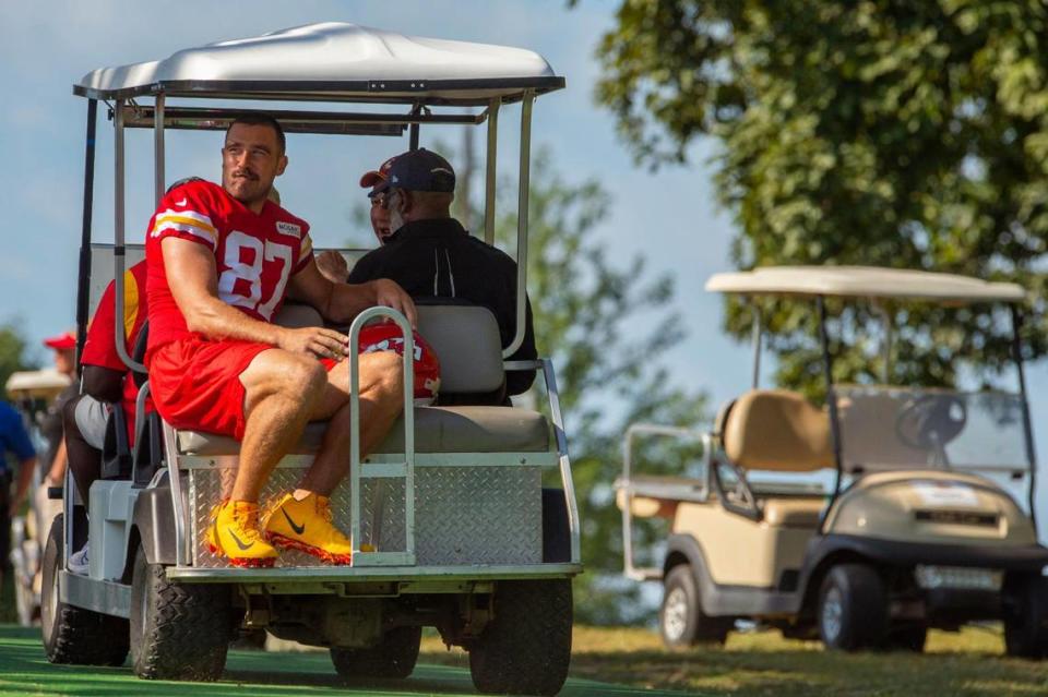 Kansas City Chiefs tight end Travis Kelce (87) catches a ride on a golf cart after the last day of practice at Chiefs training camp on Thursday, Aug. 18, 2022, in St. Joseph.