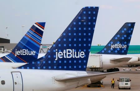 JetBlue Airways aircrafts are pictured at departure gates at John F. Kennedy International Airport in New York June 15, 2013. REUTERS/Fred Prouser/File Photo