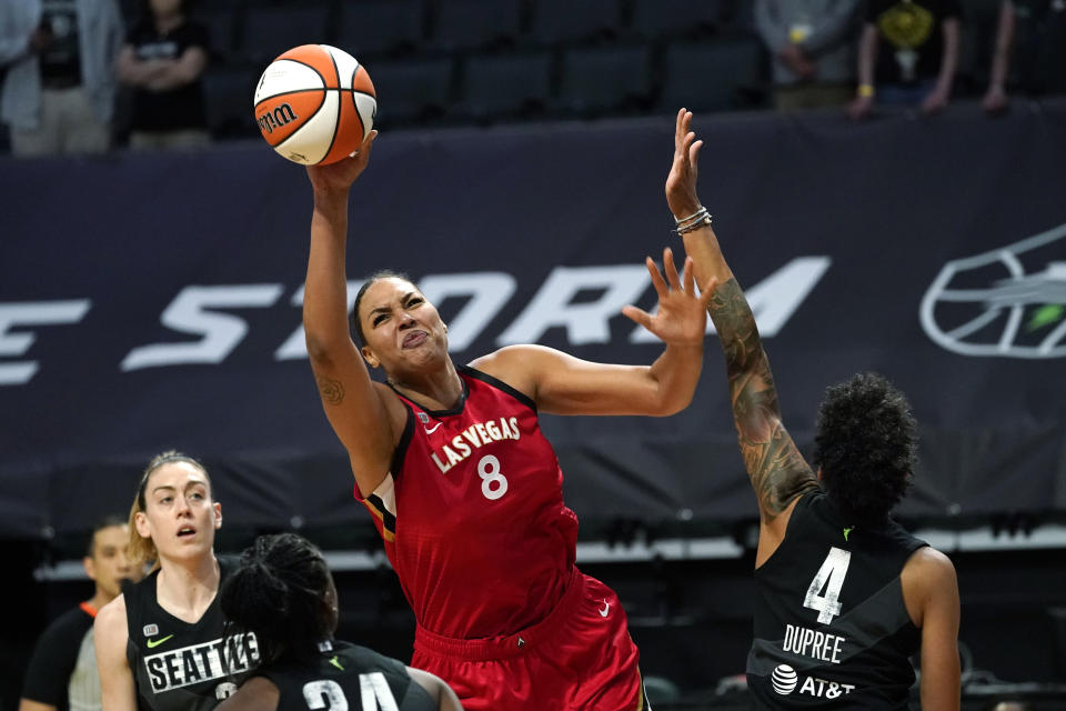 Las Vegas Aces' Liz Cambage (8) tries to get a shot off as Seattle Storm's Candice Dupree (4) defends in the first half of a WNBA basketball game Saturday, May 15, 2021, in Everett, Wash. (AP Photo/Elaine Thompson)