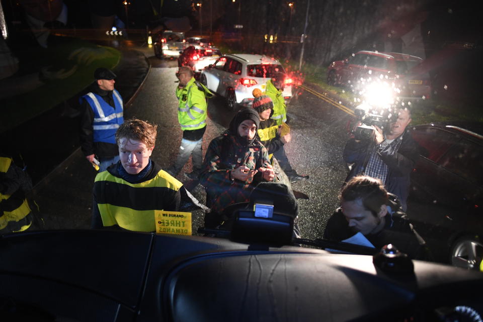 Extinction Rebellion protesters dressed as bees glue themselves to the Conservative Party campaign bus as Prime Minister Boris Johnson visits the JCB cab manufacturing centre in Uttoxeter, while on the General Election campaign trail. PA Photo. Picture date: Tuesday December 10, 2019. See PA story POLITICS Election. Photo credit should read: Stefan Rousseau/PA Wire