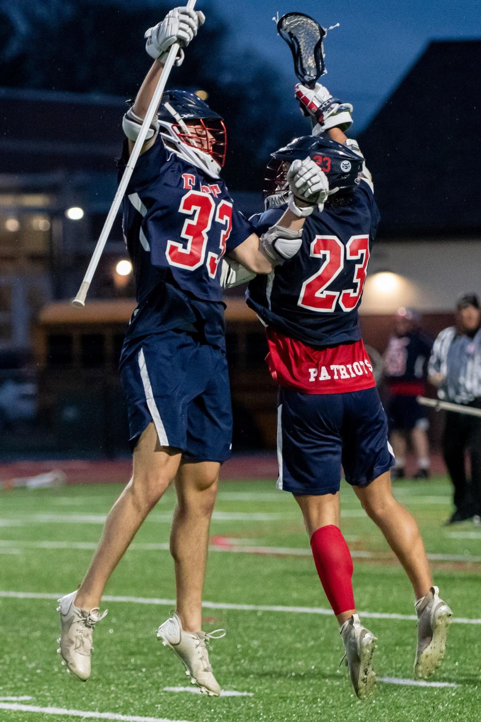 Central Bucks East's Ethan Greenlee, left, and Nicholas Knepp celebrate a goal in a boys lacrosse game against Central Bucks West at Central Bucks West High School in Doylestown, on Tuesday, April 26, 2022. The Patriots defeated the Bucks 13-7.