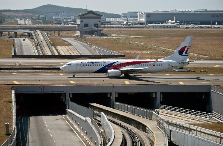 A Malaysia Airlines plane makes its way on the runway at Kuala Lumpur International Airport in Sepang on March 11, 2014