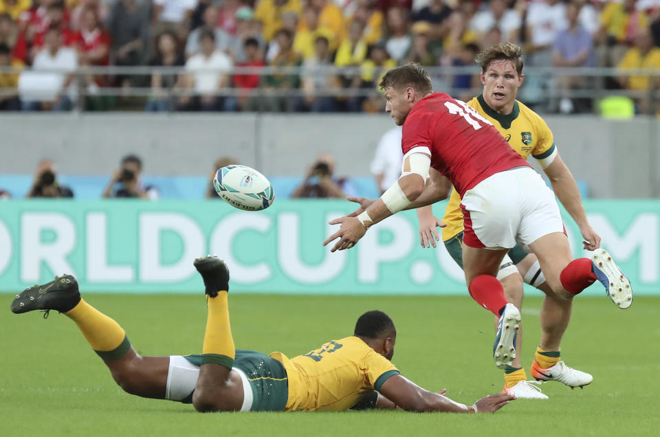 Wales Dan Biggar passes the ball during the Rugby World Cup Pool D game at Tokyo Stadium between Australia and Wales in Tokyo, Japan, Sunday, Sept. 29, 2019. (AP Photo/Eugene Hoshiko)