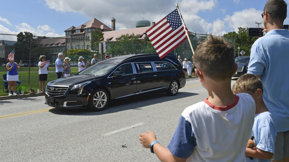 People watch as the casket of Sen. John McCain, R-Ariz., is brought to Annapolis, Md., Sunday, Sept. 2, 2018, for his funeral service and burial at the U.S. Naval Academy. McCain died Aug. 25 from brain cancer at age 81. (AP Photo/Susan Walsh)