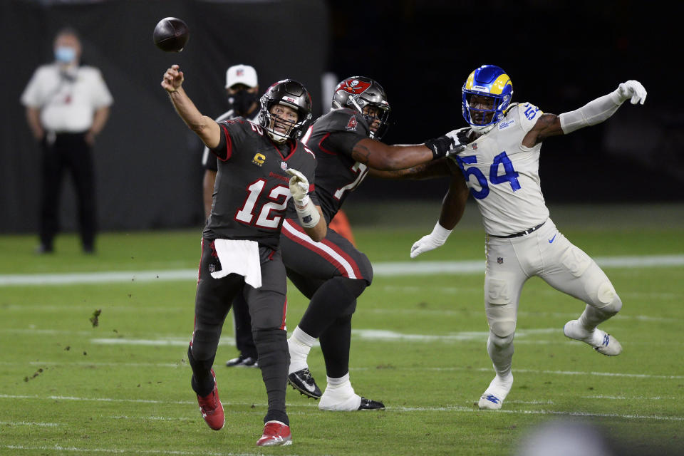 Tampa Bay Buccaneers quarterback Tom Brady (12) throws a pass as offensive tackle Tristan Wirfs (78) blocks Los Angeles Rams outside linebacker Leonard Floyd (54). (AP Photo/Jason Behnken)