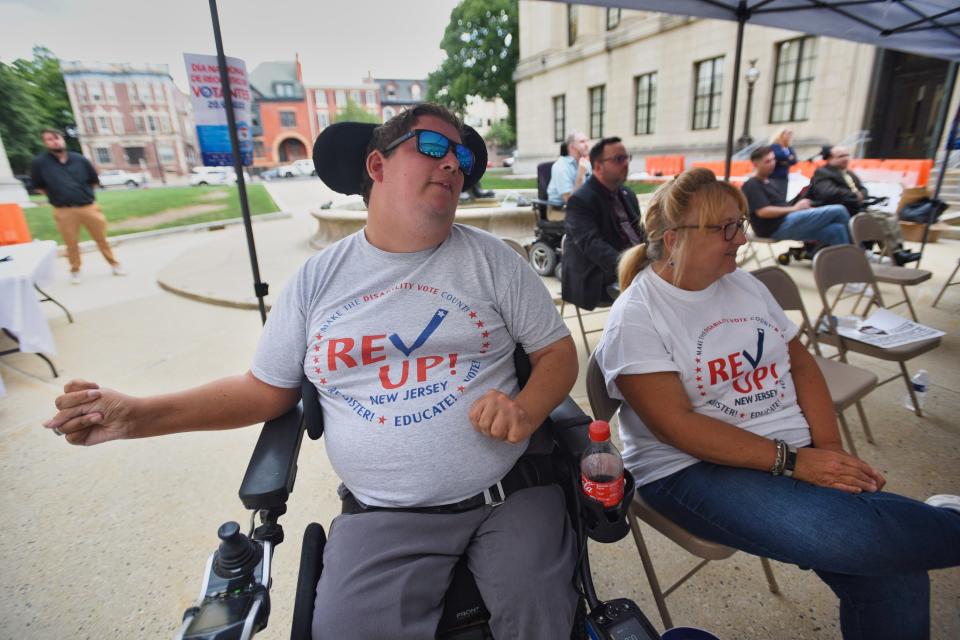Christopher Mille, 37, of Neptune and his mother Carole listen as a speaker gives a speech during the event to commemorate people with disabilities who died from COVID and asking leaders to make changes, outside of NJ State House Annex In Trenton, Monday on 09/19/22. 