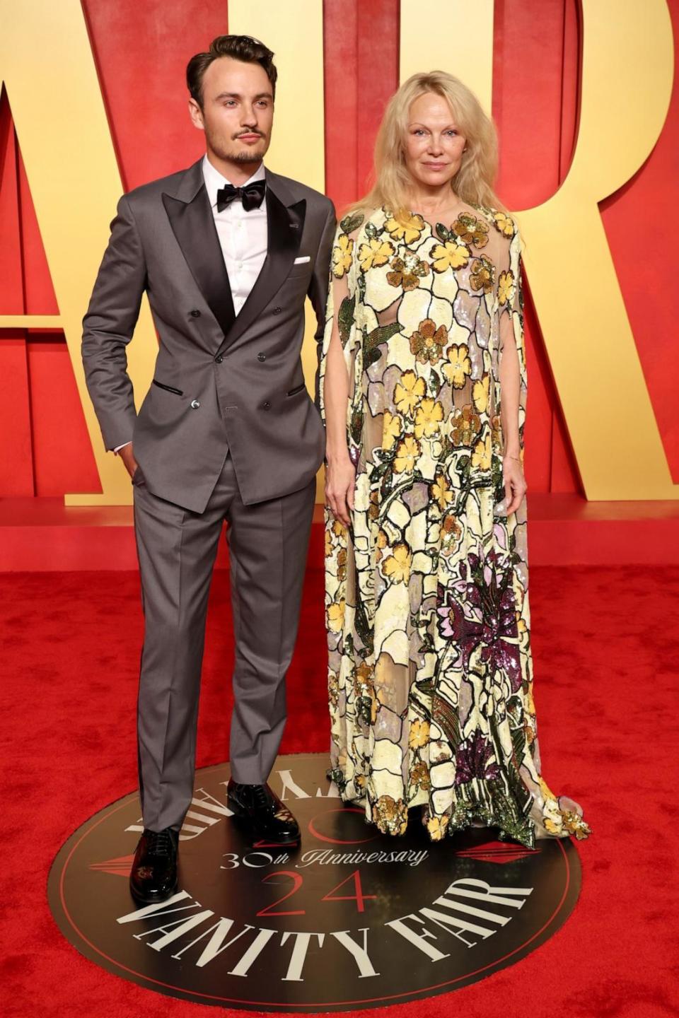 PHOTO: Brandon Thomas Lee and Pamela Anderson arrive at the Vanity Fair Oscar Party, Mar. 10, 2024, in Beverly Hills. (Amy Sussman/Getty Images)