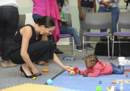 Britain's Meghan Duchess of Sussex visits the Mothers2Mothers organisation, which trains and employs women living with HIV as frontline health workers across eight African nations, in Cape Town, South Africa, Wednesday, Sept. 25, 2019. The royal couple Prince Harry and Meghan are on the third day of their African tour. (Henk Kruger / African News Agency Pool via AP)