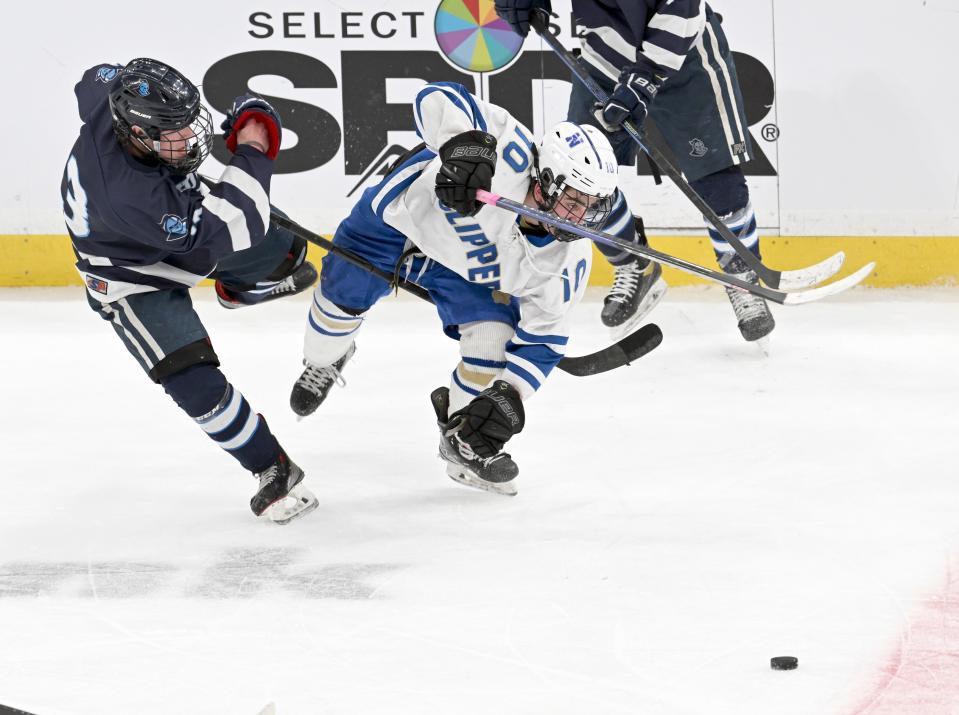 Harley Ellis of Sandwich and Nolan Petrucelli of Norwell collide as Ellis passes the puck in MIAA Division 4 final hockey March 19 at the TD Garden in Boston.