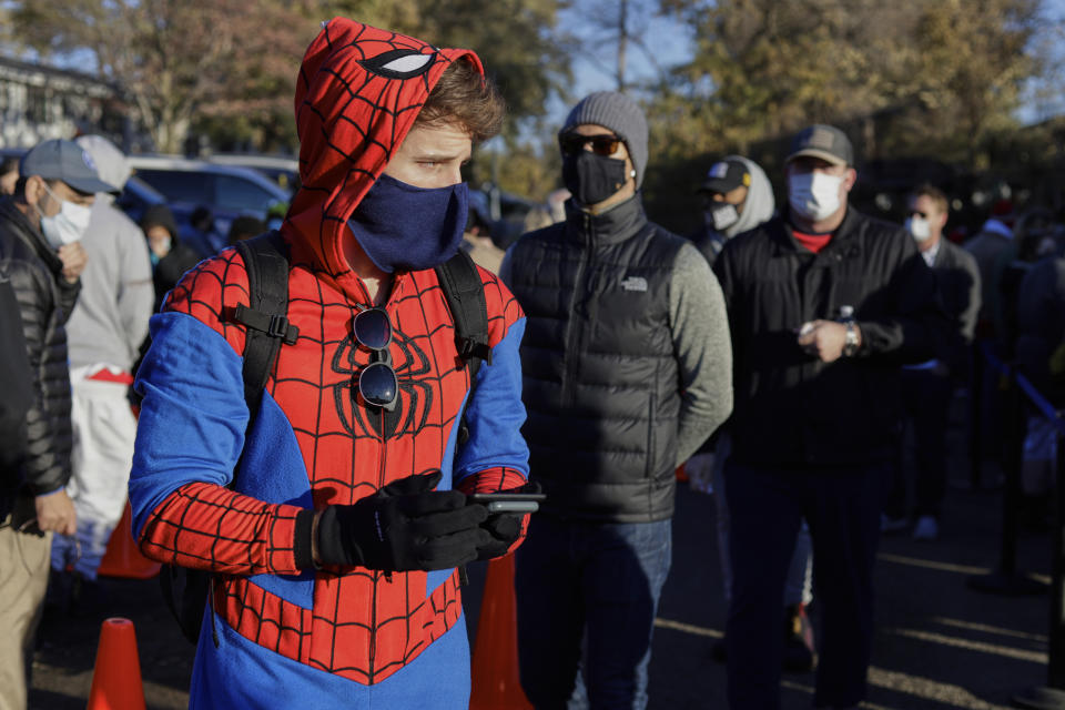 Colin Buckley of Omaha wears a Spiderman suit as he waits to cast an early vote on Halloween, at the Douglas County Election Commission office in Omaha, Neb., Saturday, Oct. 31, 2020. (AP Photo/Nati Harnik)