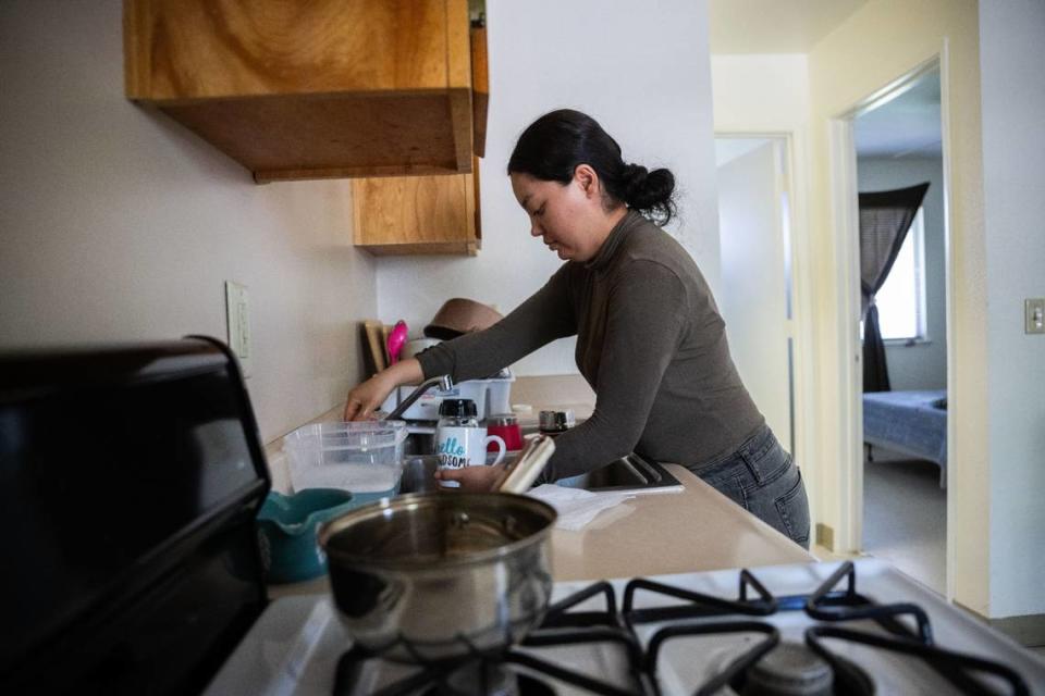 Elizabeth Saavedra Barrera washes dishes in her apartment at the Williams Migrant Center in July. Saavedra Barrera, who works in cosmetology when she returns home to Mexico after the farmwork season, said that she would like to stay Williams year round.