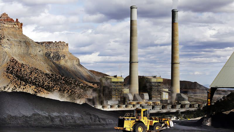 A loader moves coal at the Huntington power plant in Huntington on March 24, 2015.