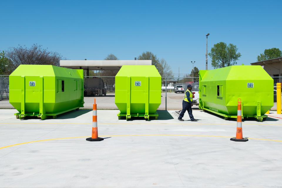 A worker walks in between recycling containers during the Grand Opening of the Jackson Recycling Center on Tuesday, Apr. 11, 2023.