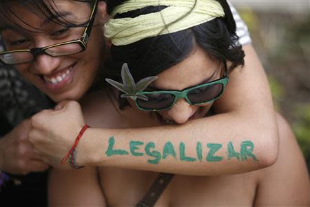 A woman embraces her friend during a rally to demand the legalization of marijuana outside the Senate building in Mexico City, in this April 20, 2012 file photo. REUTERS/Bernardo Montoya/Files