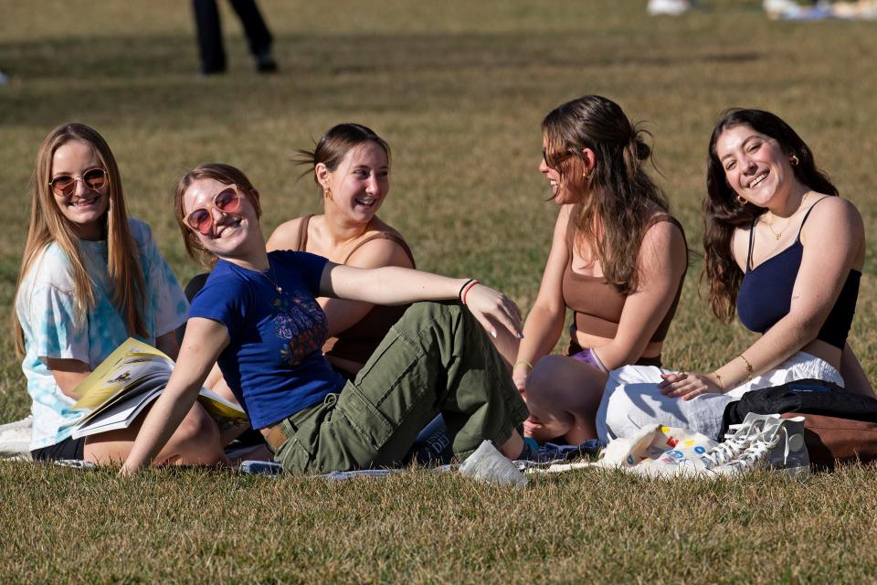 University of Delaware students enjoy a sunny and warm winter day on The Green Campus Building in Newark, Thursday, Feb. 23, 2023.