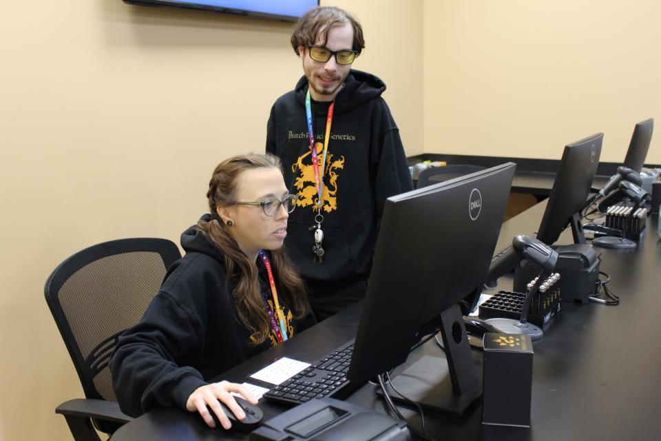 Bud-tender Hilary “Hilly” Donbrosky (left) and general manager Chris Hansen at Green Labs Provisions review store inventory online. The facility located at 10701 Madison St. in Luna Pier specializes in medical cannabis, accessories and apparel.